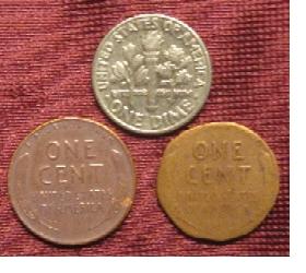 A dime at the top, a full sized penny 
to the left and a penny 'shaved' to the size of a dime to the right