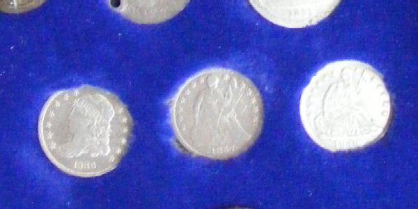 Three silver Half-Dimes. From left-to-right; 1836 Bust Half-Dime, 1857 Seated Liberty Half-Dime and an 1840 Seated Liberty Half-Dime.