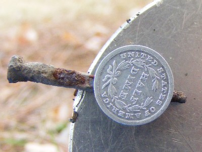 1839 Half-Dime fused to an iron nail